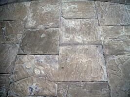 Old stone wall pattern close view background, ancient bricks surface photo