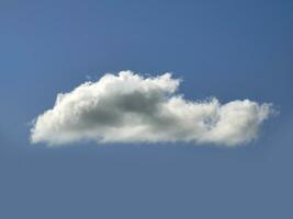 Single white cloud over blue sky background. Fluffy cumulus cloud shape photo