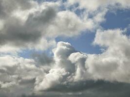 White clouds over blue sky background. Fluffy cumulus cloudscape photo