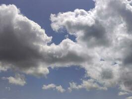 White clouds over blue sky background. Fluffy cumulus cloudscape photo