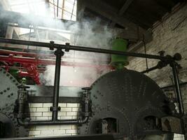 Industrial pipes at the power plant background, steam engines, ovens and boilers, factory without people photo