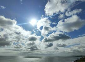 Cargo ship in the open sea. White clouds on a blue sunny sky background and sea photo