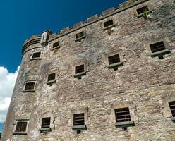 Old celtic castle tower walls, Cork City Gaol prison in Ireland. Fortress, citadel background photo