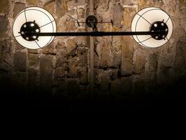 Old ancient lamps on the wall in a dark room background, gloomy light photo