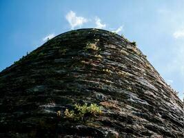 Old celtic castle tower wall close view background, Blarney castle in Ireland, dark celtic fortress photo