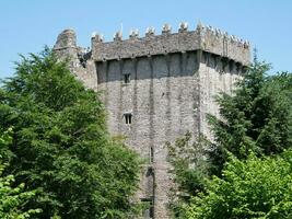 Old celtic castle tower in the trees, Blarney castle in Ireland, old ancient celtic fortress photo