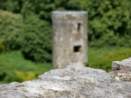 Old stone over ancient tower background, Blarney castle in Ireland, old ancient celtic fortress photo