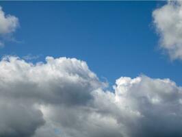 White single clouds over blue sky background. Fluffy cumulus clouds shape photo