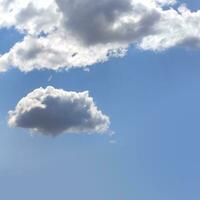 White clouds isolated over blue sky background photo