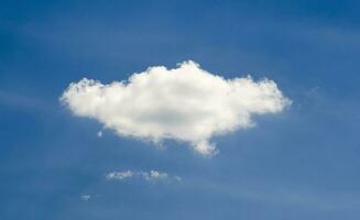 Single cloud in deep blue summer sky photo