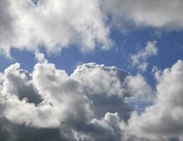 Stormy sky with white and grey clouds background photo