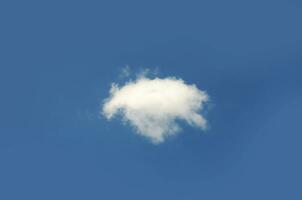 Single cloud isolated over blue sky background photo