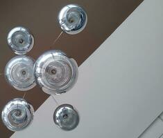 Modern chandelier background, round lamps over ceiling photo