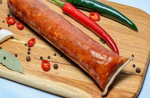 Tasty sausages and vegetables isolated over solid background photo