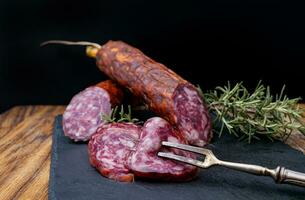 Tasty sausages and vegetables isolated over solid background photo