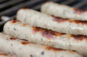 Tasty sausages isolated over solid background photo