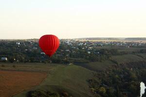 Hot air balloon over green fields photo