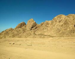 Desert land with mountains and sea photo