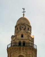 Clock tower with a weathercock photo