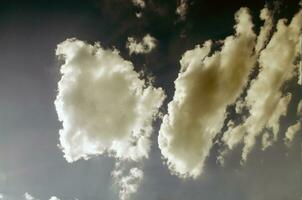 Blue sky with white clouds in sun rays photo