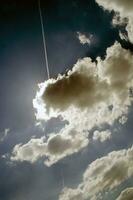 Blue sky with white clouds in sun rays photo