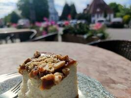 Cheese cake on a plate on a blurred city background. Gastro tour in Europe photo