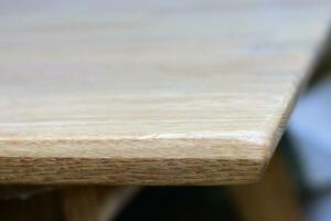 Wooden dinner table surface. Natural wood furniture close view photo