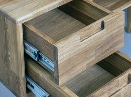 Opened drawers close view photo, wooden eco furniture elements background. Solid wood furniture details photo