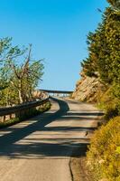 Mountain road between the rocks and forest photo