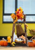 Autumn decor on the porch of the house outside in the yard of pumpkin, lantern, garlands, hats, jack lantern. Halloween party, autumn mood, Harvest festival photo