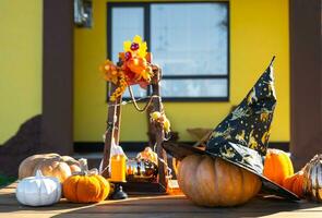 Autumn decor on the porch of the house outside in the yard of pumpkin, lantern, garlands, hats, jack lantern. Halloween party, autumn mood, Harvest festival photo