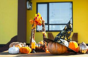 Autumn decor on the porch of the house outside in the yard of pumpkin, lantern, garlands, hats, jack lantern. Halloween party, autumn mood, Harvest festival photo