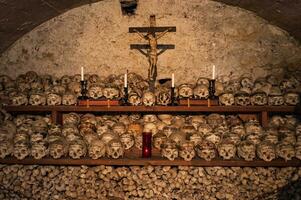 Hallstatt, Austria - 2 Apr 2018 - Skulls of dead citizens of Hallstatt painted with their names and various ornaments photo