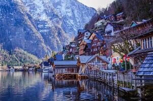 Hallstatt view from the lake with snow covered mountains on the background photo