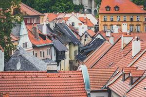 Old houses with red roofs and small windows during late afternoon photo
