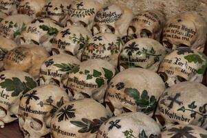 Hallstatt, Austria - 2 Apr 2018 - Skulls of dead citizens of Hallstatt painted with their names and various ornaments photo