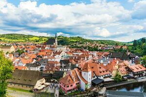 Aerial view on the old city in Czech Republic located between the green mountains and a river photo