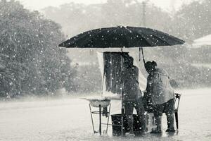 Two persons endure struggle on obstacles rainstorm photo