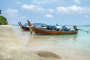 Long tail wooden boats anchored on sea in Lipe photo