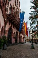 Frankfurt, Germany - Dec 25, 2018 - City hall entrance with EU, German and region flags with Christmas tree decorated photo