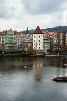 Old white tower on the border of the river photo