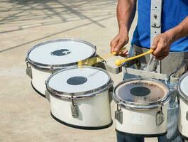 Men hitting the drum photo