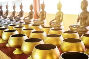 monk's alms bowl and buddha statue for largess photo