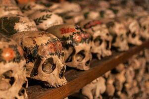 Hallstatt, Austria - 2 Apr 2018 - Skulls of dead citizens of Hallstatt painted with their names and various ornaments photo