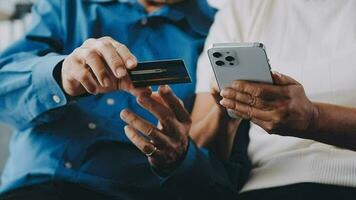 Happy couple using credit card for shopping online using laptop video