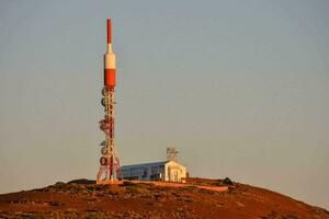 a radio tower on top of a hill photo