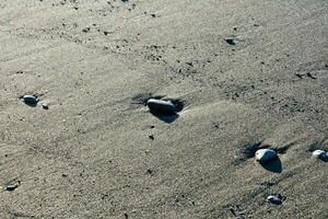 a group of rocks and pebbles on the beach photo