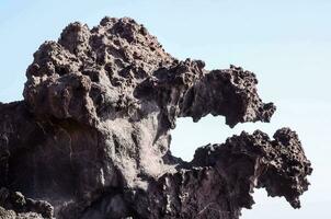 a rock formation on the side of a mountain photo