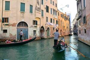 a gondola is traveling down a narrow canal in venice photo