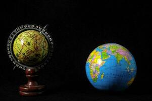 two globes on a black background photo